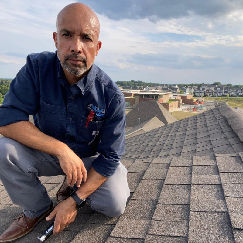 Professional home inspector on roof conducting inspection