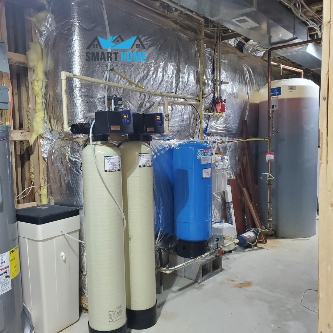 Complete well water system with pressure tanks, filtration, and treatment equipment